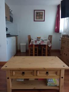 a wooden table in a kitchen with a dining room at Lugrin proche du Lac et Montagne in Lugrin