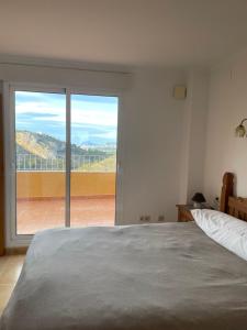 a bedroom with a bed and a large window at Cumbre Del Sol Segrelles 11 in Cumbre del Sol +14 photos