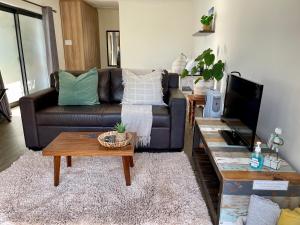 a living room with a couch and a coffee table at Nahoon Studio in East London