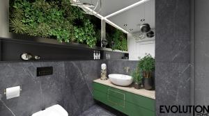 a bathroom with a sink and plants on the wall at AMuSE ME in Kielce