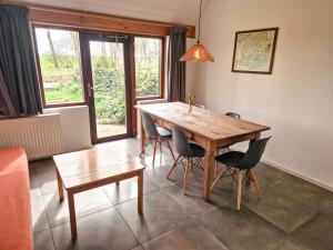 a dining room with a wooden table and chairs at De Gelukskever renovated 2024 in Hindeloopen +49 photos