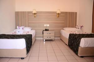 A bed or beds in a room at Sun Flower Apart Hotel