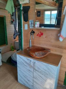 a bathroom with a sink in a tiny house at Tree house Ramona & Fairytale wooden house by Ljubljana in Grosuplje