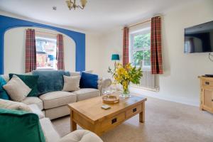 a living room with a couch and a coffee table at Enholmes Coach House in Hull