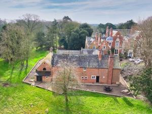 an aerial view of an old house in a field at The Yorkshire Hosts - Enholmes Coach House in Hull