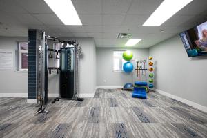 a fitness room with a gym with weights at Live Beautifully Uptown in Charlotte +5 photos