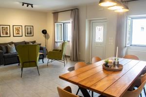 a living room with a wooden table and chairs at Alba Spacious Maisonette in Corfu