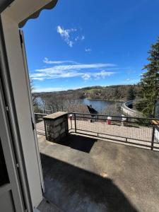 a view of a river from the balcony of a house at Maison au bord du lac in Saint-Étienne-Cantalès