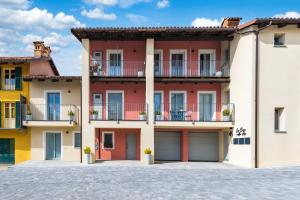 a large apartment building with balconies and garages at La Casa Nelle Aie - Appartamento Dolcetto - Free Wifi & AC in La Morra