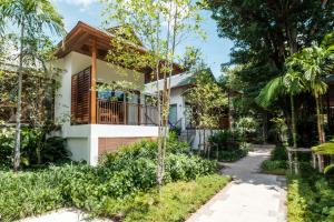 a house in the middle of a garden at Banana Fan Sea Resort in Chaweng