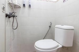 a bathroom with a toilet and a shower at OYO 93720' 3D Residence Near Univ Tarumanegara in Jakarta