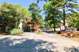 a building on a street with trees in the background at Deer Hollow Cottage at Tradewinds in Eureka Springs