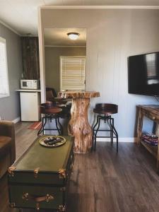 a living room with a tree stump table and chairs at Deer Hollow Cottage at Tradewinds in Eureka Springs +4 photos