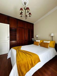 a bedroom with a large bed with a yellow blanket on it at CASA VIVA in Santa Cruz de la Palma