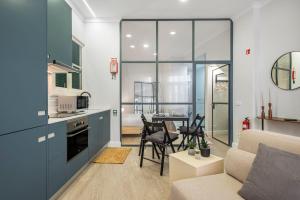 a kitchen and living room with a couch and a table at Ponte Nova Studios in Funchal