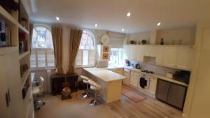a kitchen with a white counter top in a room at Spacious luxury central London 1-bed apartment in London