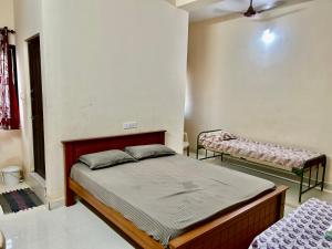 a bedroom with two beds in a room at Sundaram Rooms in Coimbatore