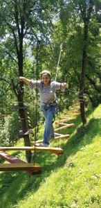 a woman on a rope swing in a park at The Himalaya Retreat Resort, Experience Nature in the Lap of Himalayas in Mussoorie