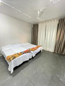 a bedroom with a large bed in a room at Tuljai Homestay in Tuljapur
