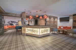 a living room with a bar and a dining room at Chalet Hotel Yeti in Tignes