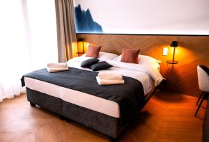 a bedroom with a large bed with pillows on it at Botel Marina in Prague