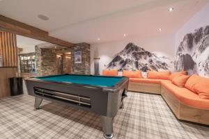 a living room with a pool table in it at Chalet Hotel Yeti in Tignes