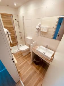 a bathroom with a toilet and a sink and a shower at Hotel St. Georg in Ediger-Eller +49 photos