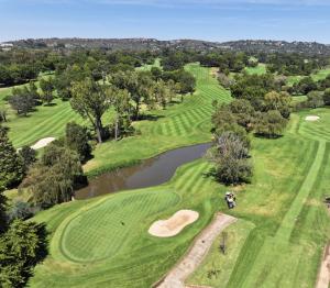 an overhead view of a golf course with a pond at City Nest:Heart of Linksfield II in Johannesburg