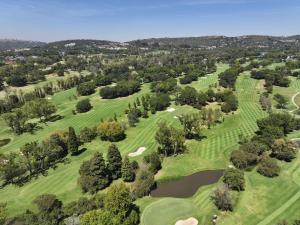 an overhead view of a golf course with a pond at City Nest:Heart of Linksfield II in Johannesburg
