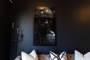 a picture of a skull on a wall next to a couch at City Nest:Heart of Linksfield II in Johannesburg