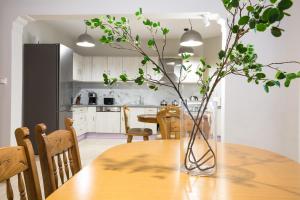 a kitchen and dining room with a table with a vase on it at Zoe's Place - 2 BD Beachfront Apartment in Kissamos