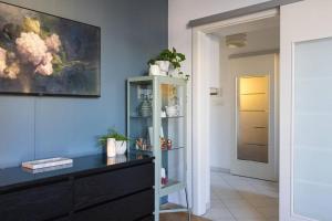 a living room with a painting on the wall at cozinesT eco apartment in Zagreb +51 photos