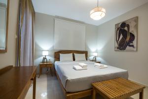 a bedroom with a bed with two towels on it at Zoe's Place - 2 BD Beachfront Apartment in Kissamos