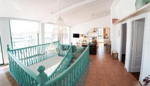 a living room with a green railing at Vila Sen Vento - Aguiño in Ribeira