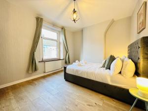 a bedroom with a bed and a window at LakeDistrict Sweetness by Sleepy in Millom