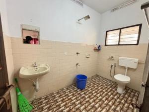 a bathroom with a sink and a toilet at Hornbill inn in Cochin