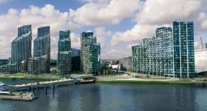 a city with tall buildings next to a river at O2 Greenwich Central City Stays in London