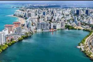 an aerial view of a city with a body of water at Condado 1 bedroom Apt w/ View in San Juan