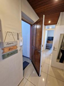 a hallway with a wooden door and a room at Apartment close to Lyon and Parc de Parilly in Saint-Priest
