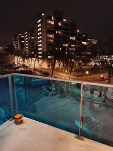 a swimming pool on top of a building at night at La Maison Bleue - La Haye in The Hague