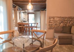 a living room with a glass table and a couch at Casale Gambini in Quattro Castella