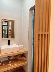 a bathroom with a sink and a mirror at Labri Home Da Lat in Da Lat