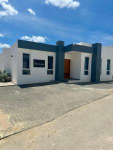 a white and blue building with a garage at Villa Sol A Luna - Mambo Beach in Willemstad