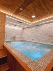 a large jacuzzi tub in a building at Vienna lux&spa in Zlatibor