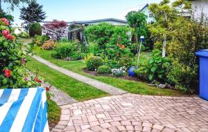 a garden with a brick path in a yard at Ferienhaus Dranske Auf Rügen in Dranske +6 photos