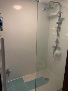 a shower with a glass door in a bathroom at Single Room near Heathrow Windsor Legoland & Free Parking Onsite in Burnham