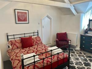a bedroom with a bed and a chair at Chapel Annex in Bodmin