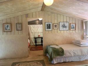 a bedroom with a bed and pictures on the wall at Hillhouse Accommodation in Howick