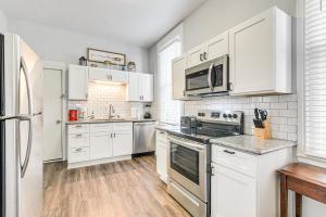 a kitchen with white cabinets and stainless steel appliances at Pet-Friendly Galveston Getaway about 1 Mi to Beach! in Galveston