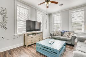 a living room with a tv and a couch at Pet-Friendly Galveston Getaway about 1 Mi to Beach! in Galveston